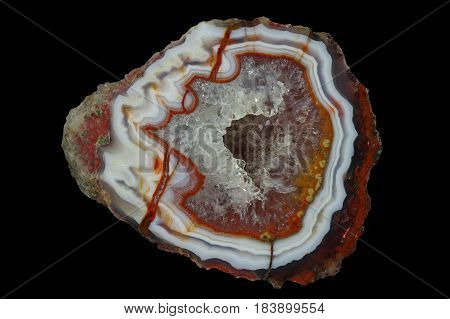 A cross section of the agate stone with quartz geode. Multicolored silica rings colored with metal oxides are visible. Origin: Asni Atlas Mountains Morocco.