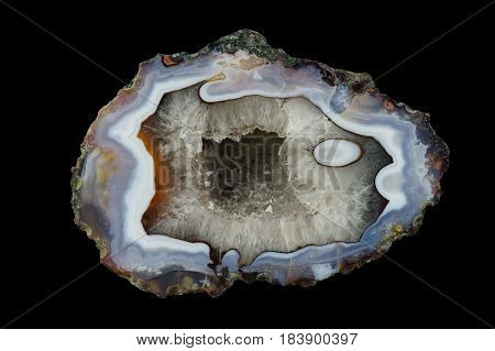 A cross section of the agate stone with quartz geode. Multicolored silica rings colored with metal oxides are visible. Origin: Asni Atlas Mountains Morocco.