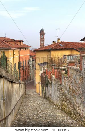 Vertikal orientierten Bild der schmalen Straße zwischen Mauern und mehrfarbige beherbergt in Saluzzo, Norden