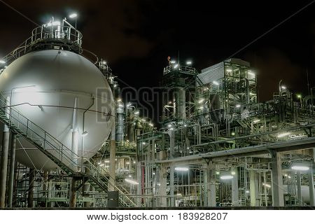 Petrochemical plant and light on night background.