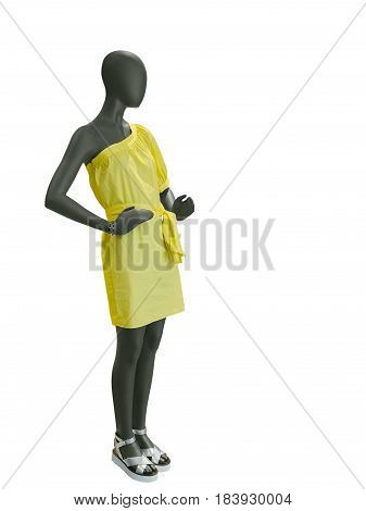 Full-length female mannequin dressed in yellow dress isolated on white background. No brand names or copyright objects.