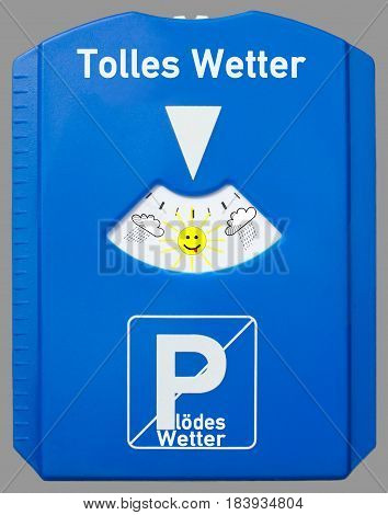 A german parking disc with the german words for summer and bad weather isolated on grey