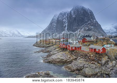 Travel Concepts and Ideas. Traditional Fishing Hut Village in Hamnoy Mountain Peak in Lofoten Islands Norway. Horizontal Image