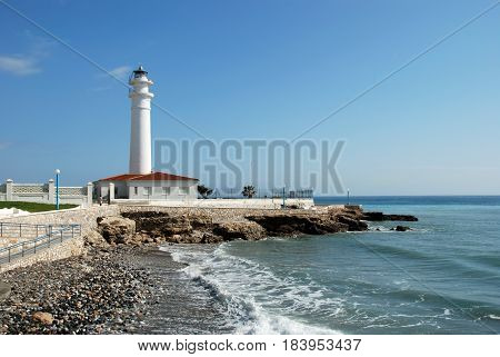 View of the whitewashed lighthouse along the rugged coastline Torrox Costa Malaga Province Andalusia Spain Western Europe.