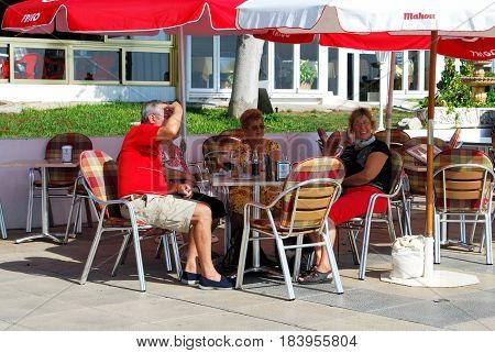 TORROX COSTA, SPAIN - OCTOBER 27, 2008 -Tourists relaxing at a pavement cafe along the promenade Torrox Costa Malaga Province Andalusia Spain Western Europe, October 27, 2008.