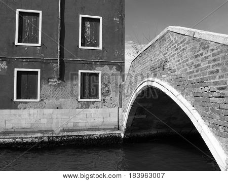 footbridge in murano venice with old building and peeling paint