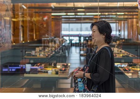 Asia Women Stand At Front Of Barbecue Restaurant