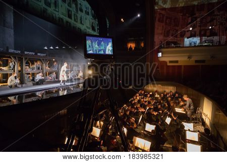 MOSCOW - JAN 25, 2017: Shooting camera, prisoners on stage and orchestra pit at Passenger performance in Moscow Theater New Opera, focus on camera