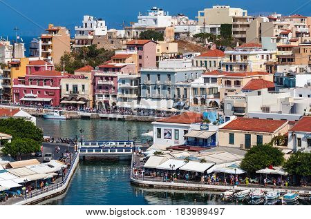 AGHIOS NIKOLAOS, CRETE, GREECE - APRIL 2017: Architecture of a small harbor at Aghios Nikolaos town on Crete island, Greece