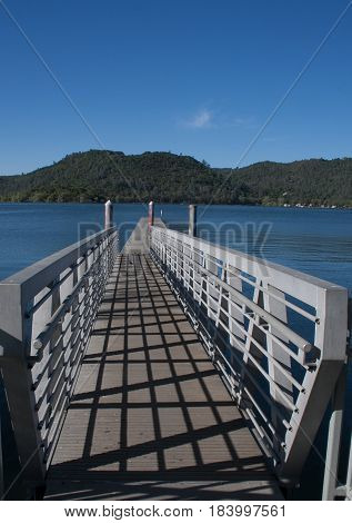 Take a long walk on a long pier leading to beautiful Clearlake with mountains in the distance
