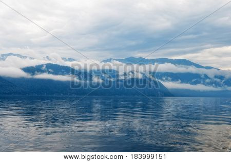 Siberia. Teletskoe lake, view of the eastern shore in the morning in cloudy weather