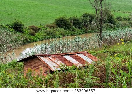 The Rusted Roof Of An Abandoned Building On The Banks Of The Karkloof River In The Natal Midlands, S