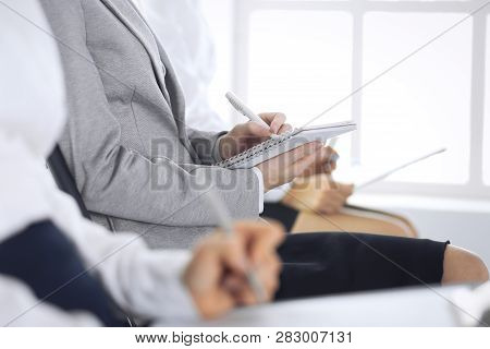 Business People Taking Part At Conference Or Training At Office, Close-up. Women Sitting On Chairs A