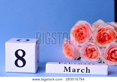 Calendar With The Date Womens Day March 8 With Peach Roses On A Purple Background.