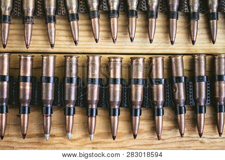 Machine Gun Ammo On A Wooden Table, Bullet Belt, Bandoleer, Chain Of Ammo On Wooden Background,cartr