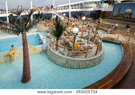 Passenger Ferry, Midsea, Spain - June 09, 2012: Passengers Enjoy At Swimming Pool On Upper Deck Of T