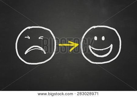Sad To Happy. Chalk Drawng On Blackboard Of Sad Crying Face Turn To Happy Smiling Face Doodle