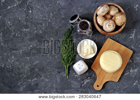 Ingredients For Cooking Baked Champignons With Suluguni On A Dark Gray Background: Raw Champignon Mu
