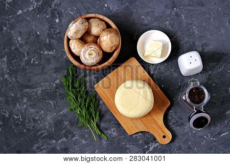 Ingredients For Cooking Baked Champignons With Suluguni On A Dark Gray Background: Raw Champignon Mu
