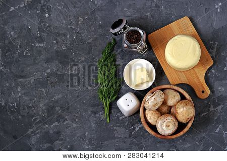 Ingredients For Cooking Baked Champignons With Suluguni On A Dark Gray Background: Raw Champignon Mu