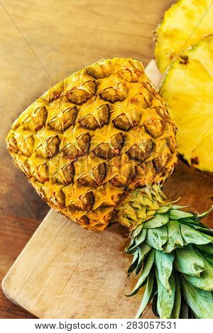 Pineapple On Wooden  Background. Whole And Sliced Tropical Pineapple. Top View. Summer Concept