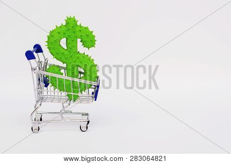 American Dollar Rubber Toy In A Mini Grocery Cart On A White Background. Copy Space.