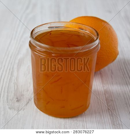 Homemade Orange Marmelade In Glass Jar On A White Wooden Background, Side View. Close-up.