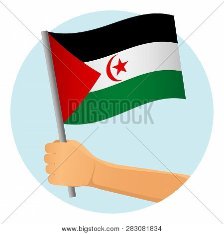 Sahrawi Arab Democratic Republic Flag In Hand. Patriotic Background. National Flag Of Sahrawi Arab D