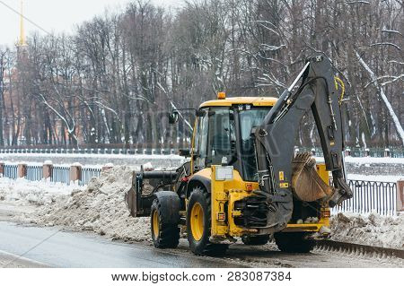 Yellow Snowblower Clears Snow From The Street After A Big Snowstorm, Shoveling Snow In The Ladle/ Sn