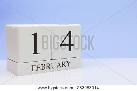February 14st. Day 14 Of Month, Daily Calendar On White Table With Reflection, With Light Blue Backg