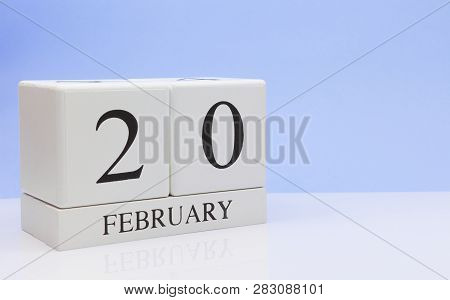 February 20st. Day 20 Of Month, Daily Calendar On White Table With Reflection, With Light Blue Backg