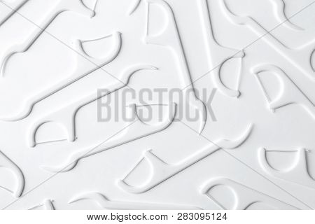 Many Dental Floss Picks On White Background, Top View. Healthy Teeth