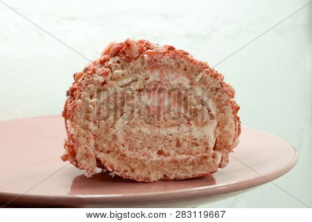 Sweet Roll With Jam And A Knife On A Cutting Board.