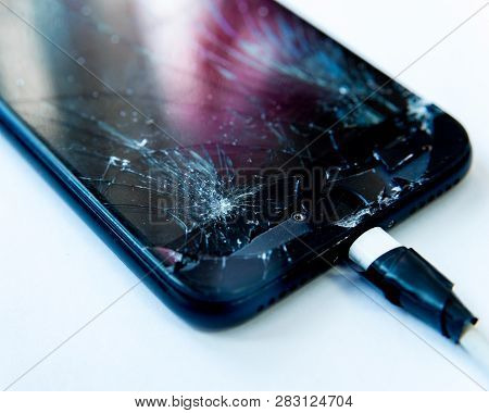 Cell Phone With The Screen Broken By A Hammer. Non-warranty Repairs Concept.