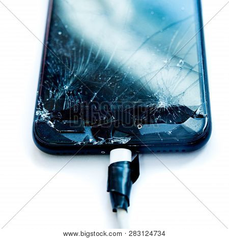Cell Phone With The Screen Broken By A Hammer. Non-warranty Repairs Concept.