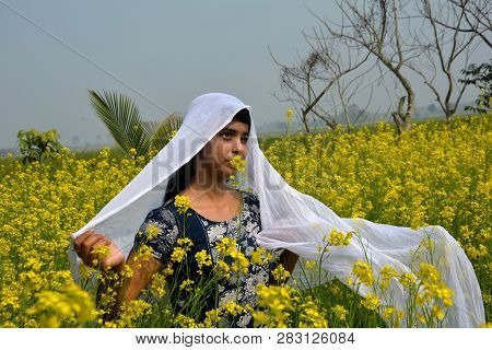 Close Up Of A Laughing Girl Wearing A Blue Salwar And Covering Her Dead With A White Cloth In  Rapes