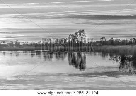 Sunset In Zinnowitz With Reflection Of The Backwater