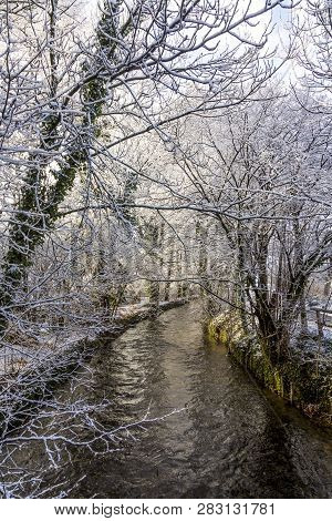 River Wuerm In Munich With Snow Covered Trees