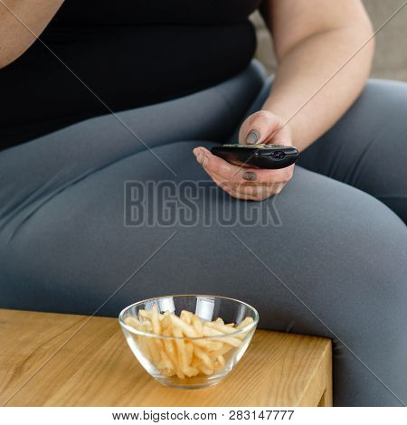 Lack Of Physical Activity, Imbalanced Nutrition, Laziness, Homebody. Lonely Fat Woman Watching Serie