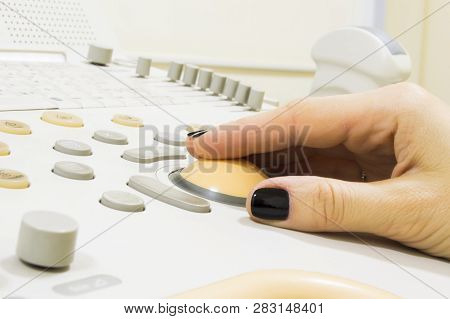 Ultrasound Examination. Hand Of Doctor Or Technician Is On Trackball Of Ultrasound Machine With Prob