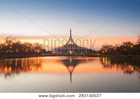 Monument In Public Park Of Thailand. Twilight Shooting Reflection On Water Concept At The Suanluang 