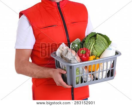 Delivery Man Holding Plastic Crate With Food Products On White Background, Closeup