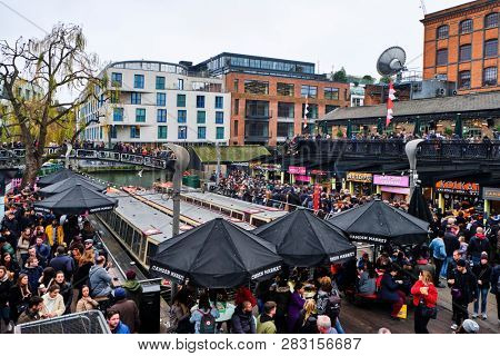 LONDON, UK - DECEMBER 30, 2018: Visitors at Camden Lock. Camden Lock, Camden Market, and streets nearby are the fourth-most popular attraction in the city, attracting 100,000 people each weekend