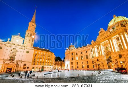 Vienna, Austria. Michaelerplatz, Wide-angle View At Dusk With Michaelkirche, Habsburg Empire Landmar