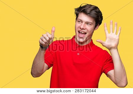 Young handsome man wearing red t-shirt over isolated background showing and pointing up with fingers number six while smiling confident and happy.