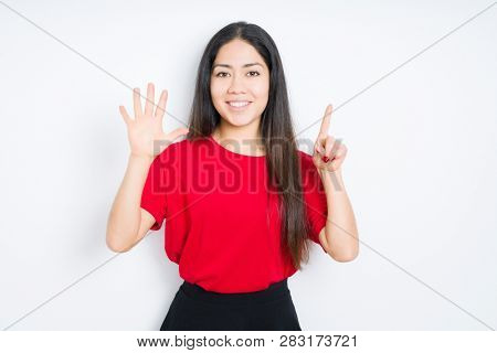 Beautiful brunette woman wearing red t-shirt over isolated background showing and pointing up with fingers number six while smiling confident and happy.