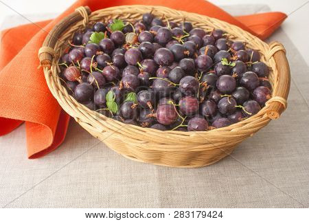 Agrus In A Basket On The Background Of A Linen Tablecloth