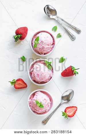 Strawberry Ice Cream And Fresh Strawberries On White Background, Top View. Three Bowls Of Strawberry
