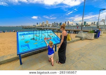 San Diego, California, United States - August 1, 2018: Mum With Child Looking Interpretive Sign Of N