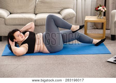 Fitness, Online Personal Trainer, Home Training, Technology And Diet. Overweight Woman Doing Crisscr